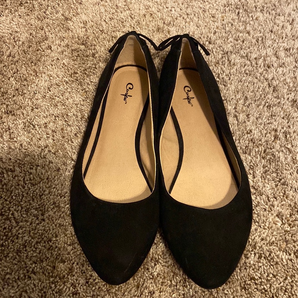Black curfew flats with a lace up bow back